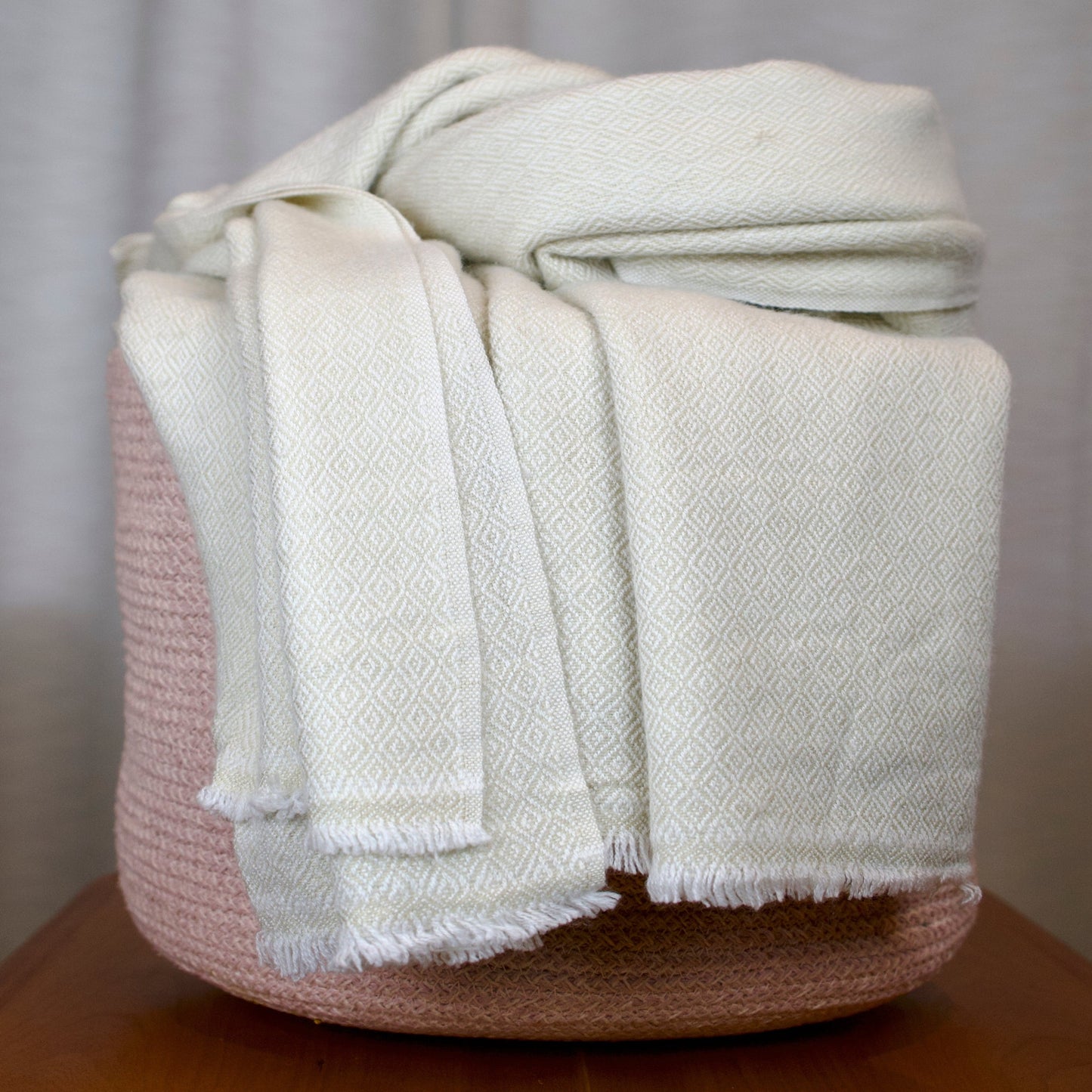 White quartz cashmere blanket on a wooden surface with a neutral background